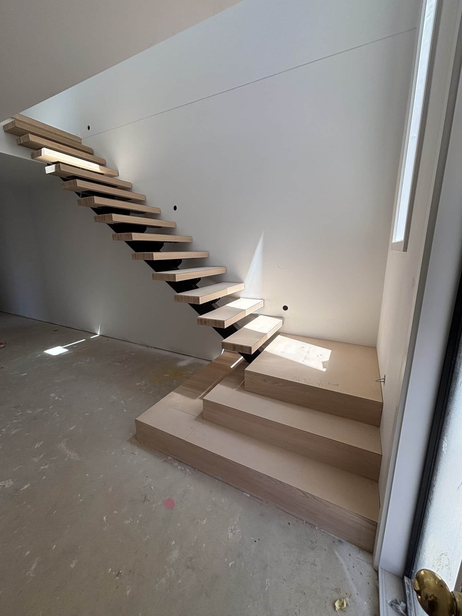 Cantilevered floating staircase with oak treads in a Brighton new build