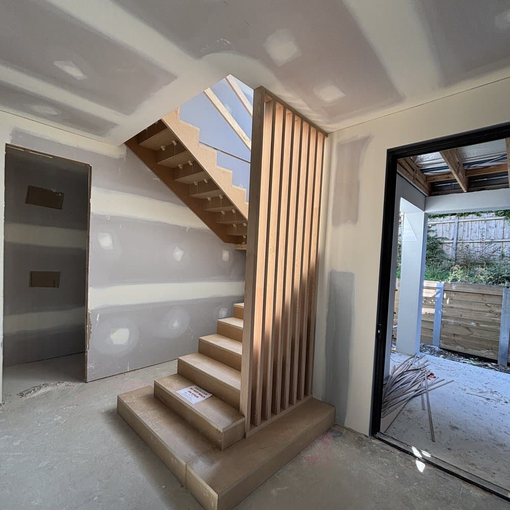 Timber slat screen alongside a stair under construction
