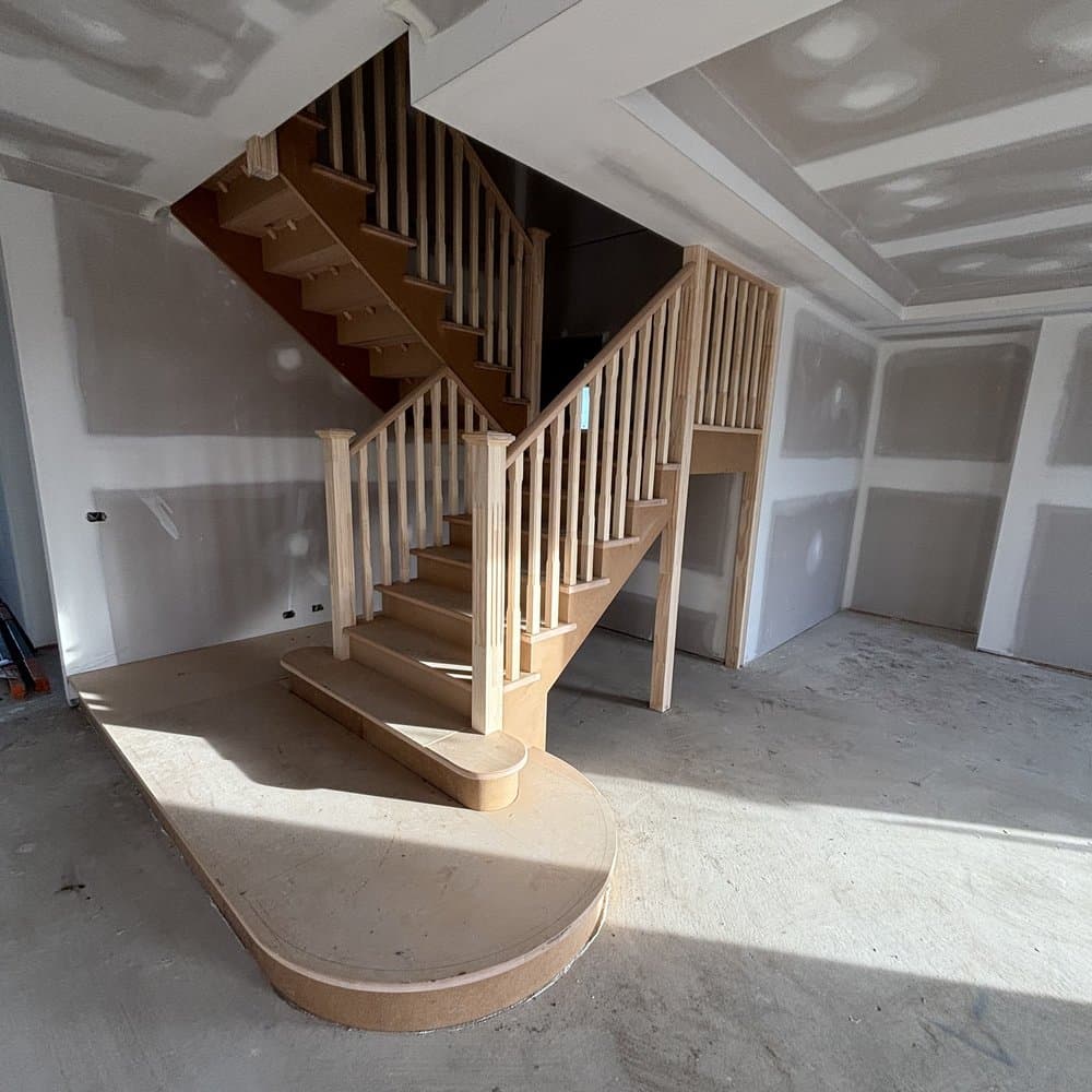 Staircase landing on a curved timber base