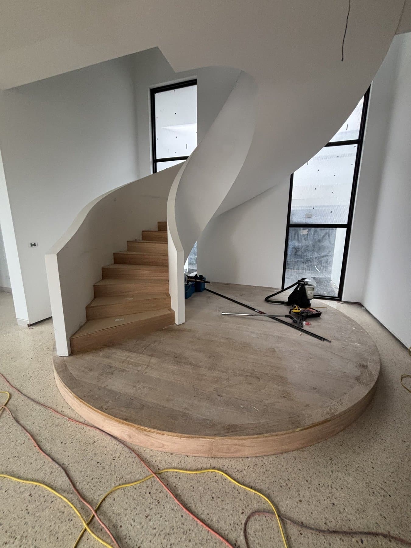 Sculptural curved staircase with circular timber landing in Mount Eliza
